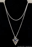 Necklace on bust showing chain drape and pendant