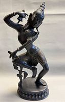 Front view of metal dancing Shiva statue on round base