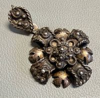 Front view showing ornate floral cross design and overall condition