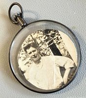 Front view of round sterling photo frame pendant with vintage photograph inside