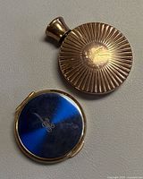 Front view of perfume bottle and compact