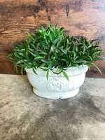 Full view of planter with faux plant showing overall design and color