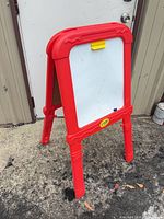 Front view showing whiteboard surface, red frame, yellow clip