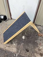 Ramp in open A-frame position showing carpeted surface and pine frame