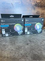 Front view of two GE Cync Direct Connect smart bulb boxes