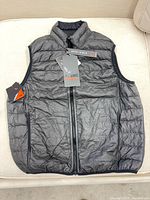 Front of gray quilted vest with tags attached