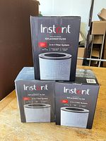 Three boxed Instant 3-in-1 replacement filters front view