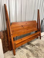 Headboard, footboard and side rails leaning against wall