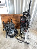 Full lot showing Kirby Avalir vacuum with caddy holding hose and attachments
