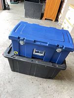 Blue tote stacked on black rolling tote, showing metal latches and overall dimensions