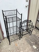 Both metal shelving units standing side by side