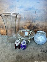 Group shot of all items: tall vase, small vase, bowl on stand, two candles