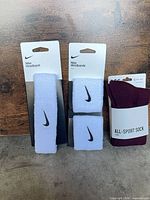 Front view of Nike headband, Nike wristbands pack, DSG socks pack