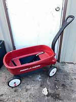 Side view of red Radio Flyer wagon with handle and wheels