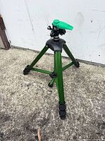 Full view of Rain Bird tripod sprinkler standing on pavement