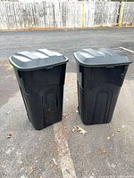 Front view of both black wheeled bins with lids closed