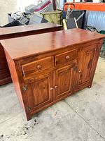 Front view of dresser showing two drawers and three cabinet doors