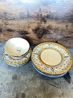 Stack of dinner plates, salad plates and bowls showing pattern and quantity