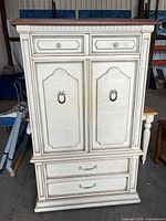 Front view showing drawers, doors, hardware