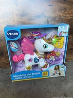 Front view of boxed VTech Starshine Unicorn showing toy and packaging
