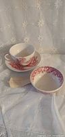 Cup on saucer beside matching small bowl and provenance note