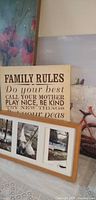 Group showing all four art pieces stacked: floral canvas, Family Rules sign, birds canvas, framed photo collage
