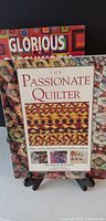 Front view showing both books: The Passionate Quilter in front, second book behind with title "Glorious" visible