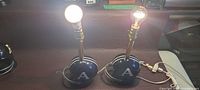 Pair of helmet lamps lit to show function