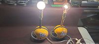 Both helmet lamps powered on with bulbs showing