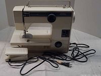 Full view of Elnita 140 sewing machine with foot pedal and power cord