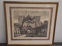 Full view of framed etching in golden wood frame