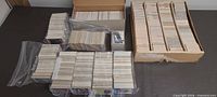 Overview of multiple boxes and stacks of loose sports cards
