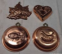 four copper-tone wall molds fish hen heart leaf front view