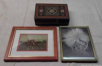 Lot overview showing box and two framed pictures