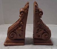 side profile of both corbels showing scroll design