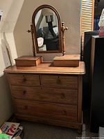 Front view of dresser showing four drawers, two top jewelry boxes, and oval mirror