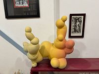 Front view of clay bubble sculpture with yellow-orange gradient