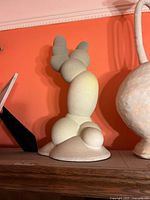 Full view of the clay sculpture on shelf