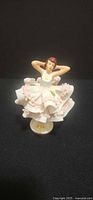 Front view of Dresden porcelain ballerina figurine showing lace skirt and pose