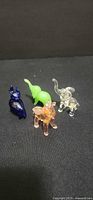 Group shot of all four glass elephant figurines in assorted colors