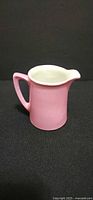 Front view of pink porcelain creamer jug