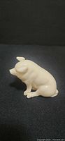Right side view of cream porcelain pig figurine