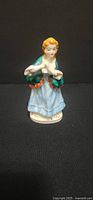 Front view of porcelain lady figurine showing colors and pose