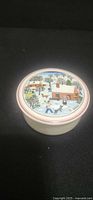 Lid with Naif Christmas scene and red rim