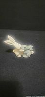 front view of glazed porcelain rabbits figurine
