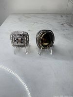 Front view of both championship rings showing faces and inscriptions