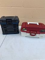 Two closed tackle boxes side by side showing exterior condition and colours