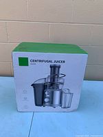 Front of sealed box showing centrifugal juicer image and model JF210S