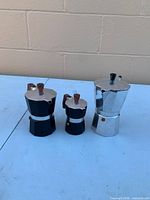 Front view of three moka pots showing sizes and colors