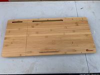 Top view of bamboo lap desk tray showing slots and handle